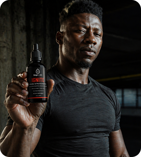 Man holding DropIn Labs IGNITE libido and performance tincture bottle
